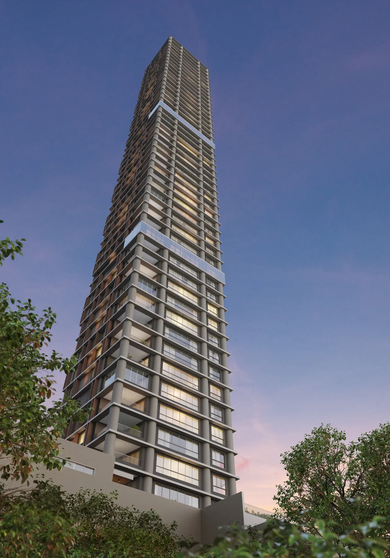 Torre residencial esbelta vista de baixo ao entardecer, entre árvores